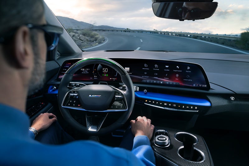Front View of the 2026 OPTIQ-V Driving Through the Dusk Utilizing its Headlights | Victory Cadillac in Petaluma CA